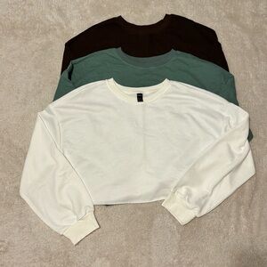 Three cropped sweatshirts